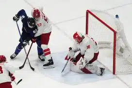 Team ROC goalkeeper Ivan Fedotov (28) makes a save in front of Team Finland forward Harri Pesonen (82) and Team ROC defender Alexander Nikishin (57) in the third period during the Beijing 2022 Olympic Winter Games at National Indoor Stadium.