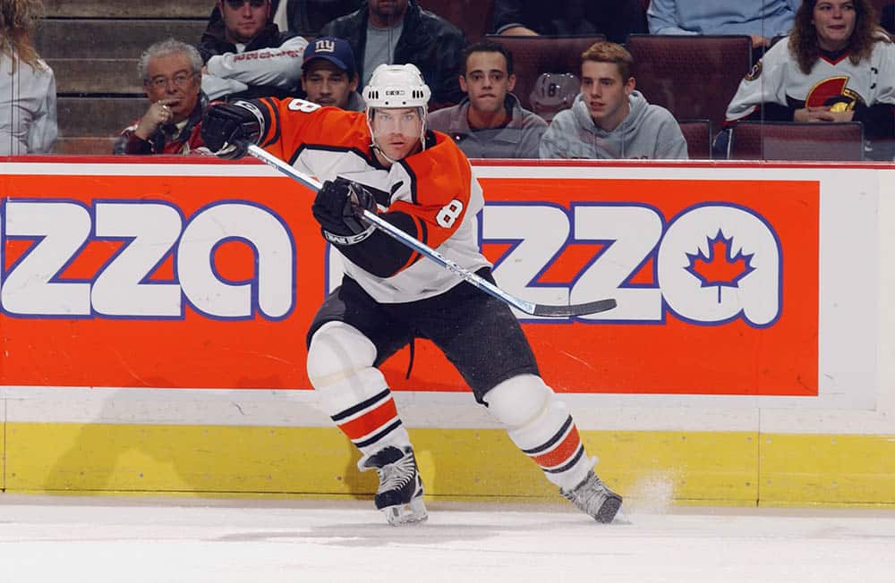 Former Philadelphia Flyers' center Bobby Clarke bows his head