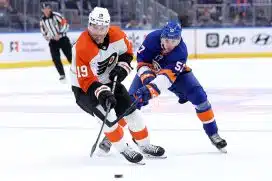 Philadelphia Flyers right wing Garnet Hathaway (19) fights for the puck against New York Islanders left wing Eetu Liukas (57) during the third period at UBS Arena.