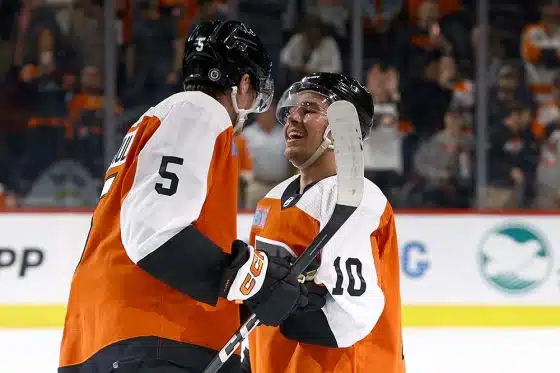 Egor Zamula #5 and Bobby Brink #10 of the Philadelphia Flyers react after defeating the Minnesota Wild at Wells Fargo Center on October 26, 2023 in Philadelphia, Pennsylvania.
