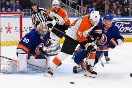 Philadelphia Flyers right wing Bobby Brink (10) and New York Islanders center Jean-Gabriel Pageau (44)] battle for the puck in front of New York Islanders goaltender Ilya Sorokin (30) during the first period at UBS Arena.