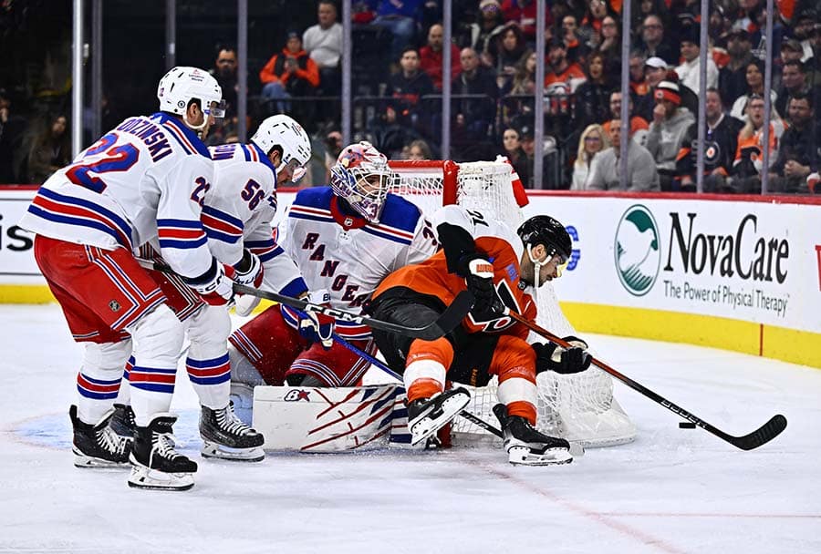 Philadelphia Flyers center Scott Laughton (21) dives for a loose puck against New York Rangers goalie Igor Shesterkin (31) in the third period at Wells Fargo Center.