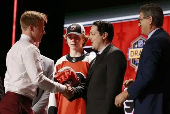 Matvei Michkov (L) shakes the hand of general manager Daniel Briere of the Philadelphia Flyers onstage after being selected seventh overall by the Philadelphia Flyers the 2023 Upper Deck NHL Draft - Round One at Bridgestone Arena on June 28, 2023 in Nashville, Tennessee.