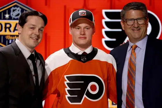 Matvei Michkov stands onstage with general manager Daniel Briere and Keith Jones after being selected seventh overall by the Philadelphia Flyers the 2023 Upper Deck NHL Draft - Round One at Bridgestone Arena on June 28, 2023 in Nashville, Tennessee.