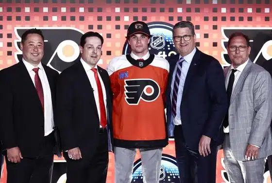 Jett Luchanko poses for a group photo with general manager Daniel Briere (2nd from L) president Keith Jones (2nd from R) and team personnel after being selected 13th overall by the Philadelphia Flyers during the first round of the 2024 Upper Deck NHL Draft at Sphere on June 28, 2024 in Las Vegas, Nevada.