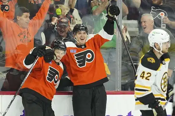 PHILADELPHIA, PENNSYLVANIA - SEPTEMBER 28: Matvei Michkov #39 of the Philadelphia Flyers celebrates with Egor Zamula #5 in front of Georgii Merkulov #42 of the Boston Bruins after scoring the game wining goal in overtime during the preseason game at the Wells Fargo Center on September 28, 2024 in Philadelphia, Pennsylvania. The Flyers defeated the Bruins 3-2 in overtime.