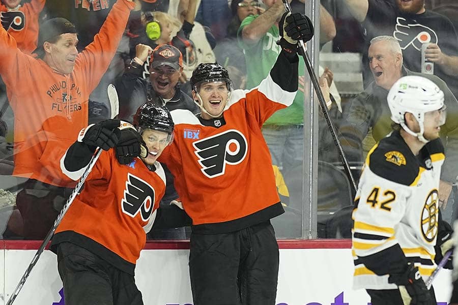 PHILADELPHIA, PENNSYLVANIA - SEPTEMBER 28: Matvei Michkov #39 of the Philadelphia Flyers celebrates with Egor Zamula #5 in front of Georgii Merkulov #42 of the Boston Bruins after scoring the game wining goal in overtime during the preseason game at the Wells Fargo Center on September 28, 2024 in Philadelphia, Pennsylvania. The Flyers defeated the Bruins 3-2 in overtime.