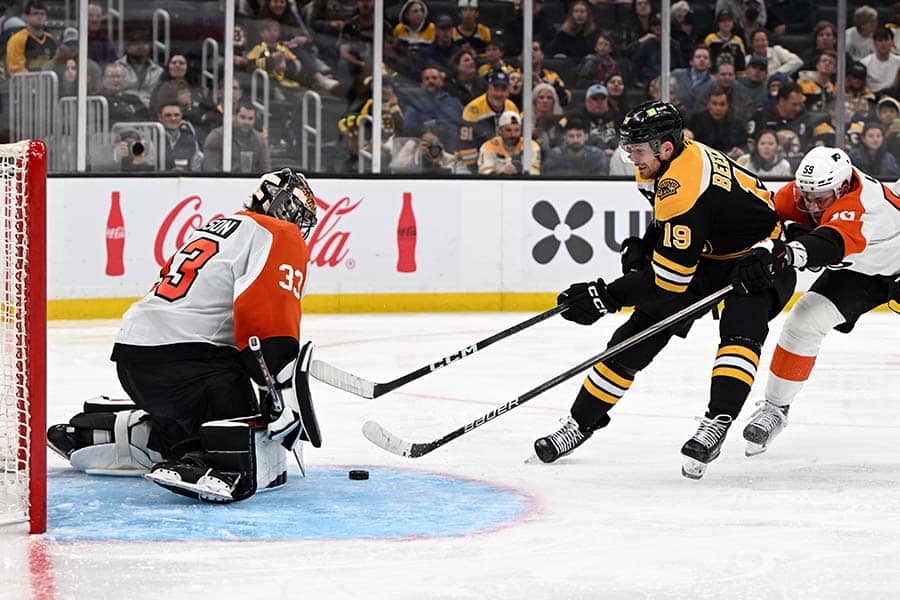 Oct 1, 2024; Boston, Massachusetts, USA; Boston Bruins center John Beecher (19) attempts a shot against Philadelphia Flyers goaltender Samuel Ersson (33) during the third period at the TD Garden.