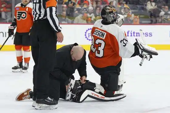 PHILADELPHIA, PENNSYLVANIA - NOVEMBER 2: Assistant equipment manager John Peters of the Philadelphia Flyers fixes the skate blade of Samuel Ersson #33 of the Philadelphia Flyers against the Boston Bruins in the first period at the Wells Fargo Center on November 2, 2024 in Philadelphia, Pennsylvania.