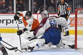 Nov 18, 2024; Philadelphia, Pennsylvania, USA; Colorado Avalanche goaltender Justus Annunen (60) makes a save against Philadelphia Flyers defenseman Travis Sanheim (6) during the third period at Wells Fargo Center.