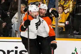 Nov 27, 2024; Nashville, Tennessee, USA; Philadelphia Flyers center Sean Couturier (14) celebrates after his goal defenseman Rasmus Ristolainen (55) against the Nashville Predators during the the overtime period at Bridgestone Arena.