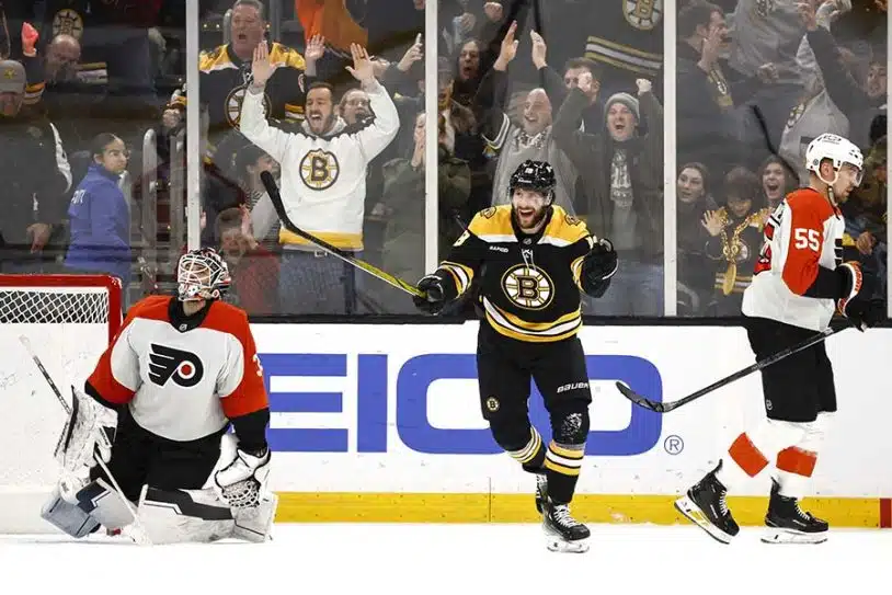 Dec 7, 2024; Boston, Massachusetts, USA; Boston Bruins center Pavel Zacha (18) celebrates after scoring the game winning goal in overtime on Philadelphia Flyers goaltender Aleksei Kolosov (35) as defenseman Rasmus Ristolainen (55) skates away at TD Garden.