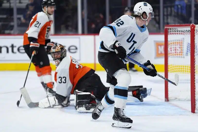 Dec 8, 2024; Philadelphia, Pennsylvania, USA; Utah Hockey Club center Logan Cooley (92) scores a goal against the Philadelphia Flyers in the second period at Wells Fargo Center.