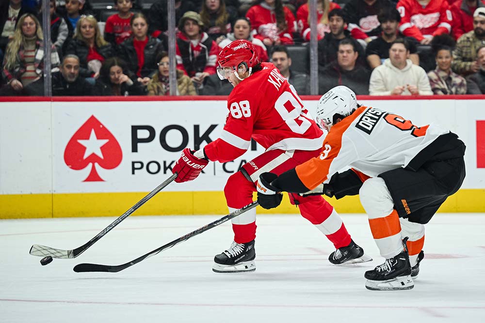 Dec 18, 2024; Detroit, Michigan, USA; Detroit Red Wings right wing Patrick Kane (88) brings the puck up ice against Philadelphia Flyers defenseman Jamie Drysdale (9) during the second period at Little Caesars Arena.